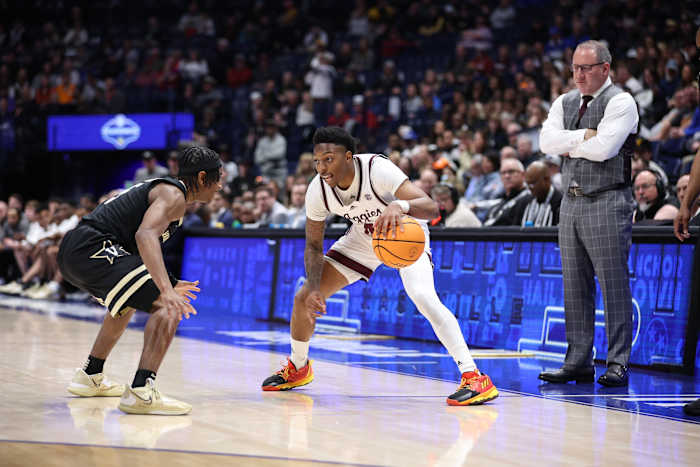 Texas A&M Aggies guard Wade Taylor IV dribbles the ball against a Vanderbilt defender during the SEC tournament in Nashville, Tennessee.